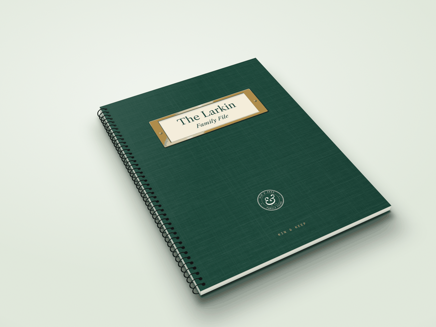 The Family File printed book, coil-bound with an evergreen cover and a brass label holder